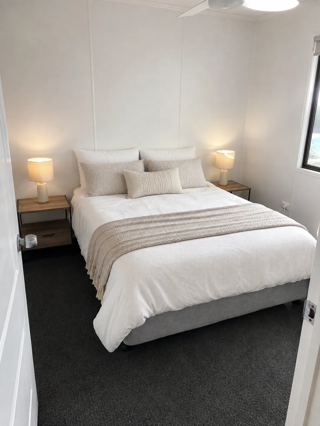Master bedroom at Cozy on Hudson holiday home in Port Lincoln with queen bed, crisp white linen, bedside lamps and ceiling fan