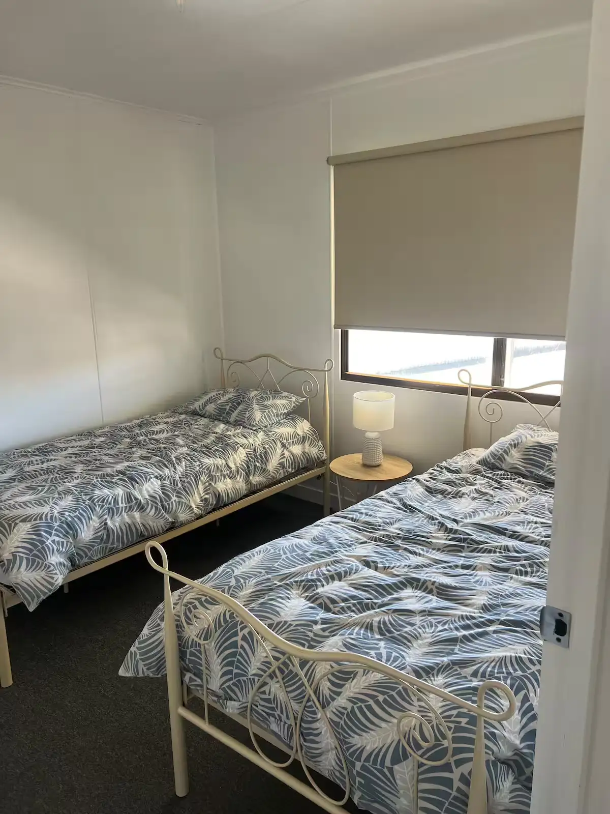Third bedroom at Cozy on Hudson in Port Lincoln with two single beds and a large window