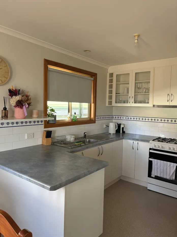 Fully equipped kitchen at Cozy on Pearson, a Port Lincoln holiday home, with electric cooktop, oven and generous bench space